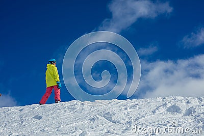 Girl snowboarder having fun in the winter ski resort. Stock Photo