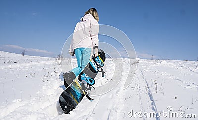 Girl snowboarder with a snowboard on a white snow. Stock Photo