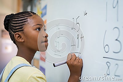 Girl solving mathematical addition Stock Photo
