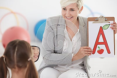 Girl during speech therapy Stock Photo