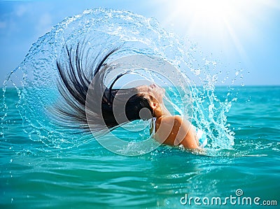 Girl Splashing Water with her Hair Stock Photo