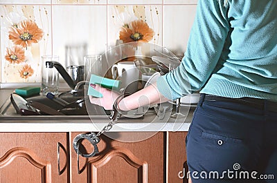 Fragment of the female body, handcuffed to the kitchen counter Stock Photo