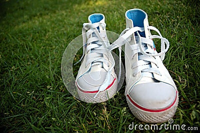 Girl sport shoes in the grass Stock Photo