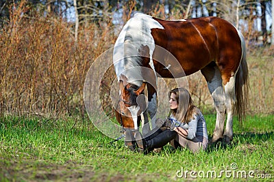 Girl sportswoman and her horse in the spring Stock Photo