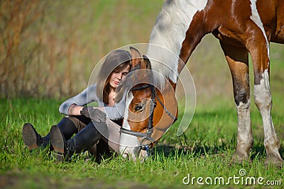 Girl sportswoman and her horse in the spring Stock Photo