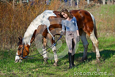 Girl sportswoman and her horse in the spring Stock Photo