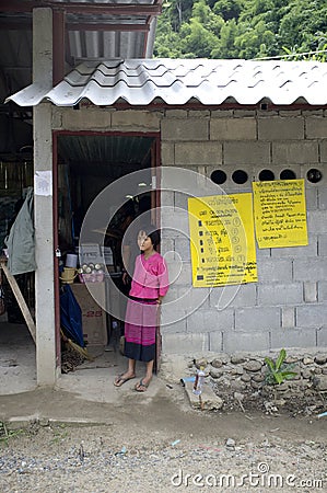 A girl stand beside a door in a Thailand village Editorial Stock Photo