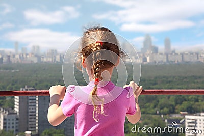 girl stand of roof of high building Stock Photo