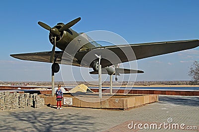 The girl is standing near airplane SU-2 BB-1 in Volgograd Editorial Stock Photo