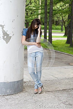 Girl standing near column Stock Photo