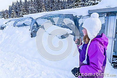 A girl standing near magicagic carpet ski lift in a glass tunel. Snowy winter day in the french ski resort. Stock Photo