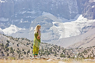 Girl standing near the mountain lake Stock Photo