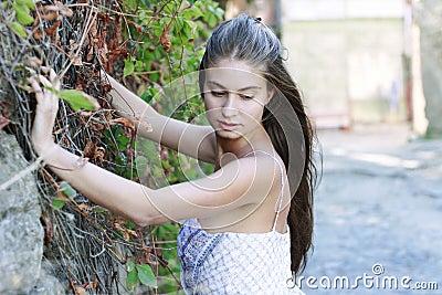 Girl is standing near the wall Stock Photo