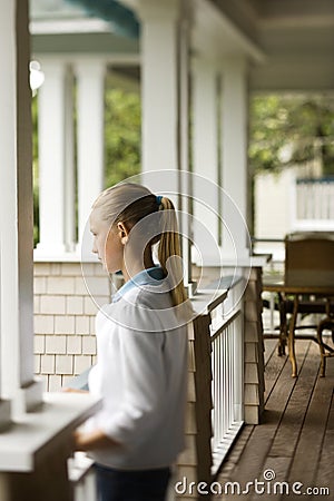 Girl standing on porch. Stock Photo