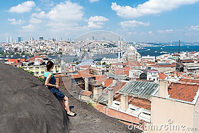 Girl standing on the roof and looking at city Istanbul Stock Photo