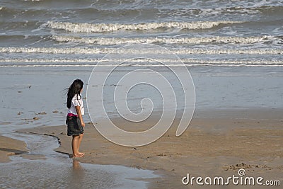 A girl standing at the sea on Chao Samran beach, Phetchaburi, Thailand Editorial Stock Photo