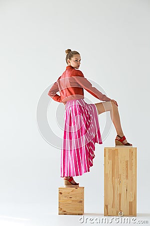 The girl stands with her back on the cubes. Stock Photo