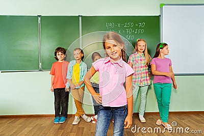 Girl stands near blackboard with numbers Stock Photo