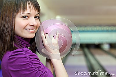 Girl stands sideways and smiles with ball in hands Stock Photo