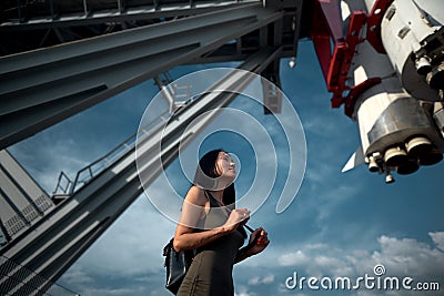 Girl stands under a spaceship Stock Photo