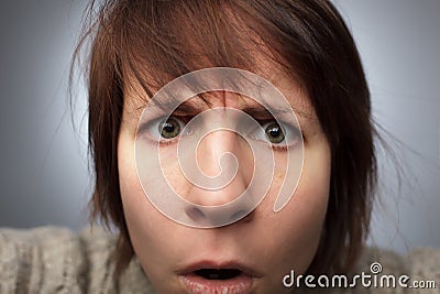 Girl stares into the camera: misunderstanding and confusion Stock Photo