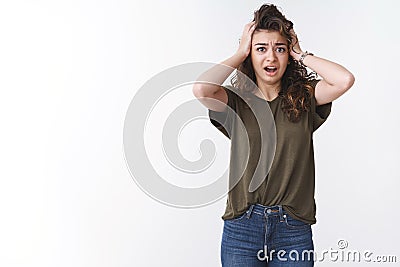 Girl start panic worried nothing prepared in time, standing shocked stunned grab head concerned grimacing bothered Stock Photo