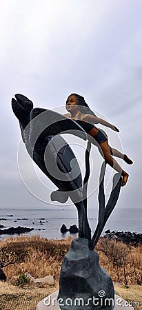 A girl statue with a turtle and seaweed Stock Photo