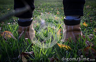 Girl steps on the grass at sunset Stock Photo