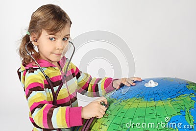 Girl with stethoscope and big inflatable globe Stock Photo