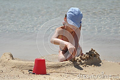 Girl sticky sand castles. The sea and beach in an exotic country. Stock Photo