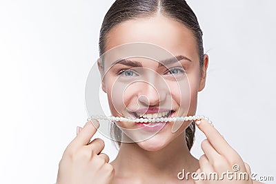 Girl with a string of pearls in his mouth Stock Photo