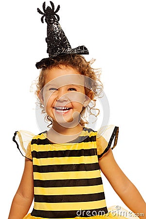 Girl in striped bee costume wearing spider hat Stock Photo