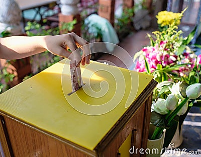 Girl student donate money for temple Stock Photo