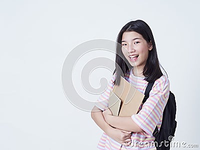 Girl student holding books with backpacks Stock Photo