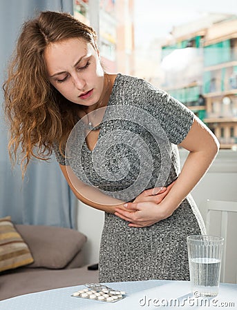 Girl suffering from abdominal pain Stock Photo