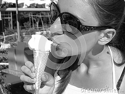 Girl in sunglasses eats ice cream Stock Photo