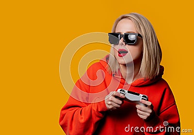 Girl in sunglasses keen plays with a joystick Stock Photo