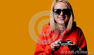 Girl in sunglasses keen plays with a joystick Stock Photo