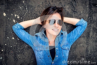 Girl with sunglasses laughing and smiling, hanging out on roof of building. Young active lifestyle people concept Stock Photo