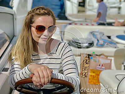 Girl in sunglasses travels on a yacht Stock Photo