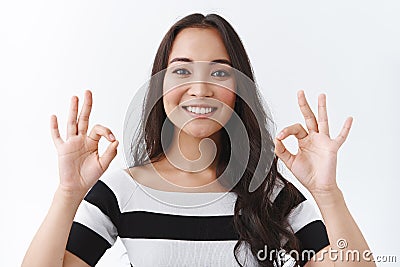 Girl supports your choice, totally agree. Happy pretty asian woman show okay, ok gesture and smiling with agreement Stock Photo