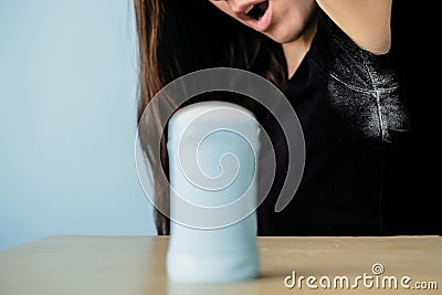 Girl surprising by deodorant stains on black clothes Stock Photo