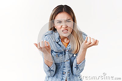 Girl swearing cursing cruel unfair life losing chance participate event. Upset intense annoyed hateful asian blond girl Stock Photo