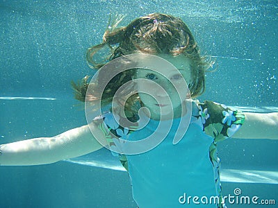 Girl swimming underwater Stock Photo