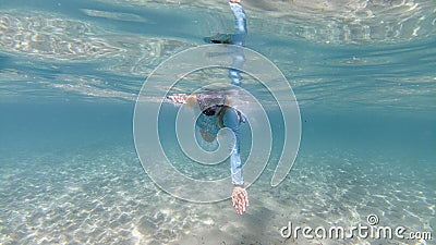 Girl swimming underwater in crystal turquoise lagoon Stock Photo