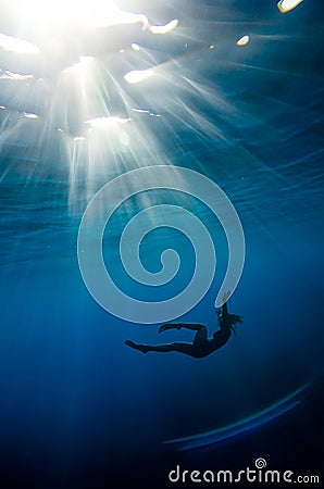 Girl swimming underwater Stock Photo