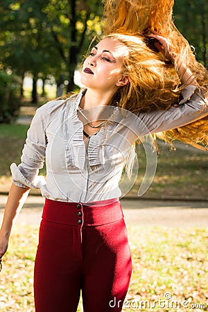 Girl swinging hair in the park Stock Photo