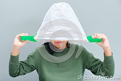 Girl take the plastic bag over her head Stock Photo