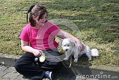 Girl takes a break and cuddles with her dog Stock Photo