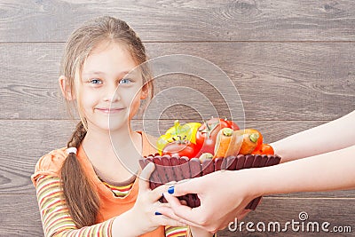 girl takes hands basket with vegetables Stock Photo